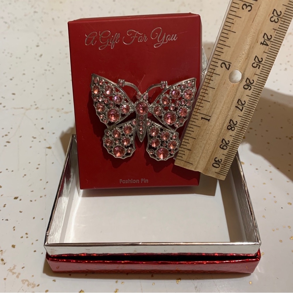 Silver Toned Pink Rhinestone Butterfly Pin. About 2” wide and 1 1/2” tall.